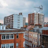 London rooftops with brick flats and 1960s tower blocks.