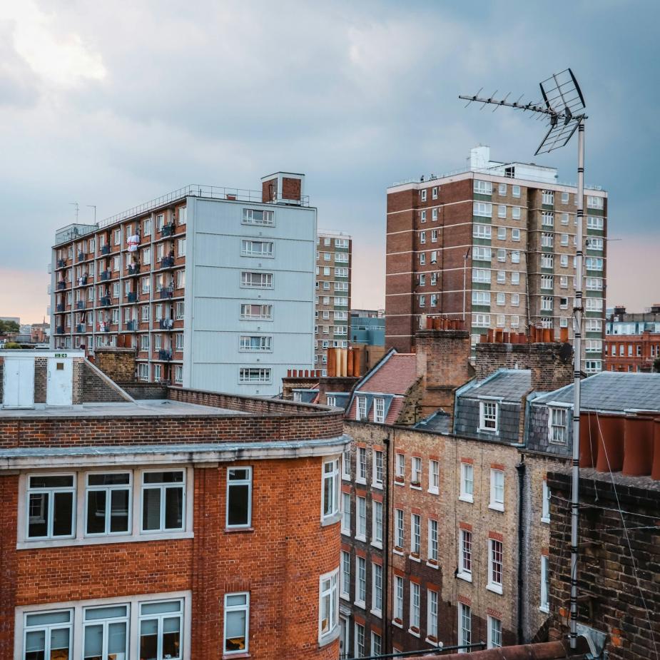 London rooftops with brick flats and 1960s tower blocks.